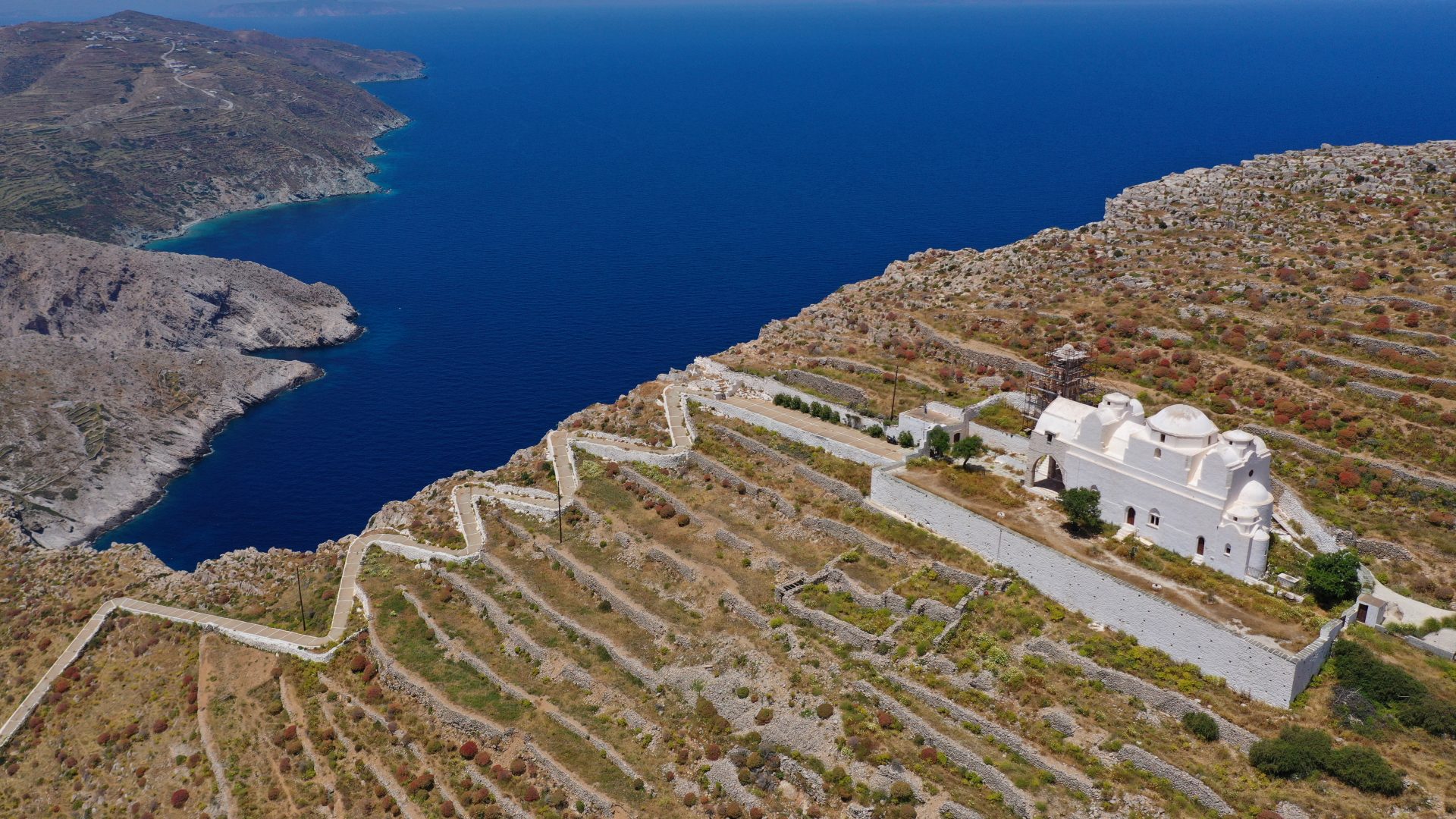 Aerial drone photo of picturesque uphill church of Panagia (Virgin Mary) with stunning views to chora of Folegandros